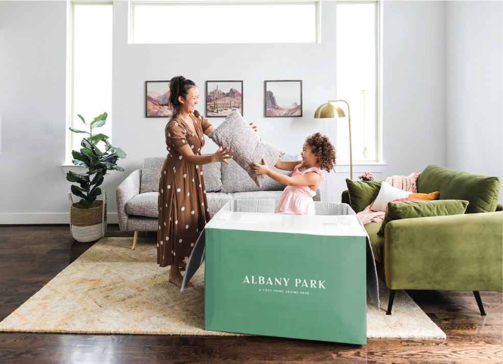 child in albany park box handing mother a pillow