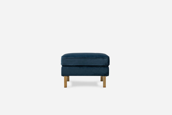 albany ottoman shown in blue velvet with gold legs