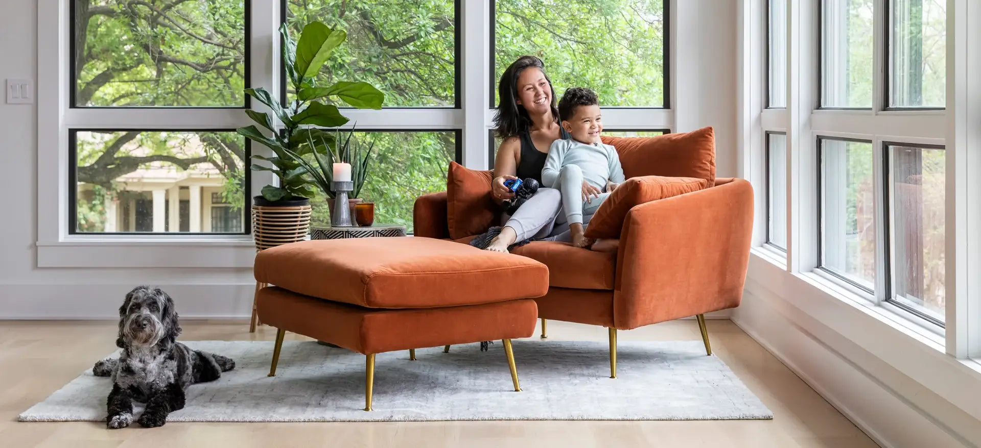 Woman and child seating in the Park Armchair in rust velvet