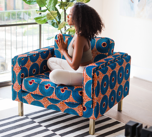 woman meditating on Ẹkáàbọ̀ albany arm chair in koyo velvet