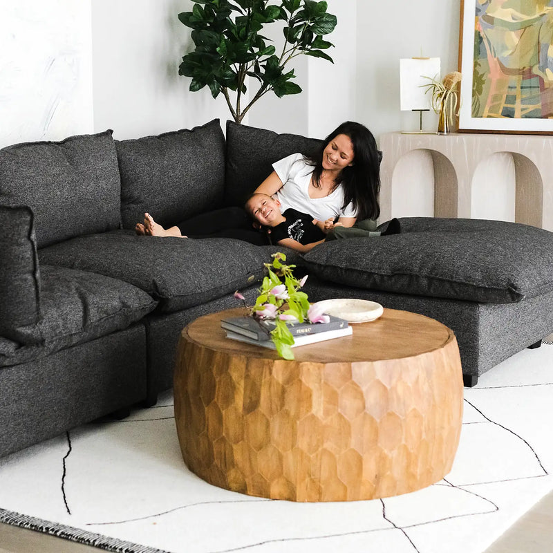 Woman and toddler lounging on the Kova Sofa and Ottoman in Charcoal