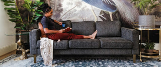 Woman sitting on the Albany Sofa in Charcoal