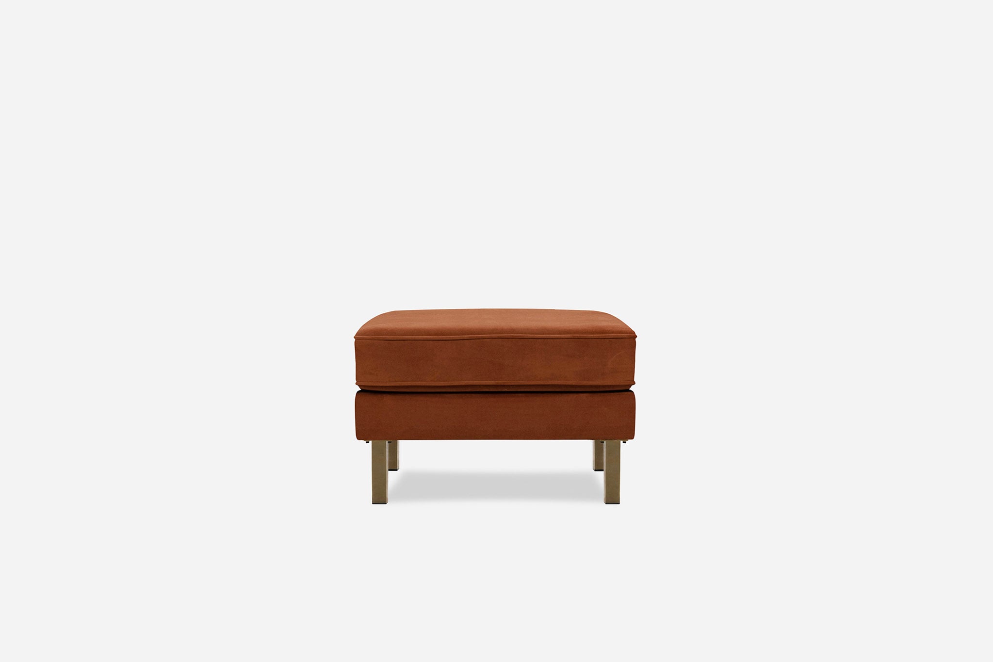 albany ottoman shown in rust velvet with gold legs
