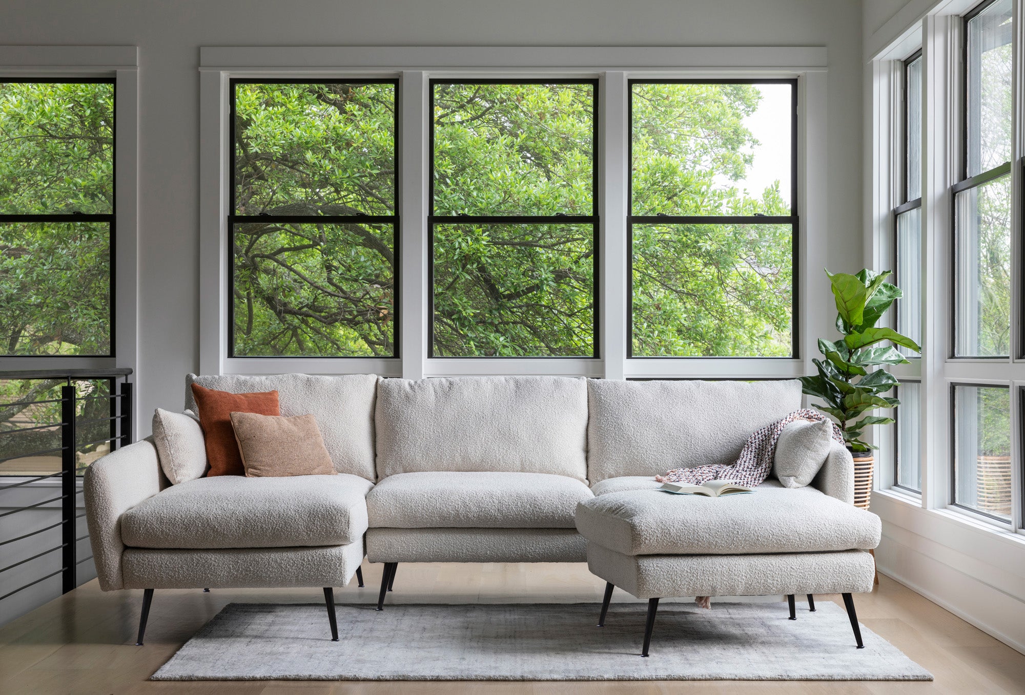 park sectional sofa shown in bouclé with black legs left facing