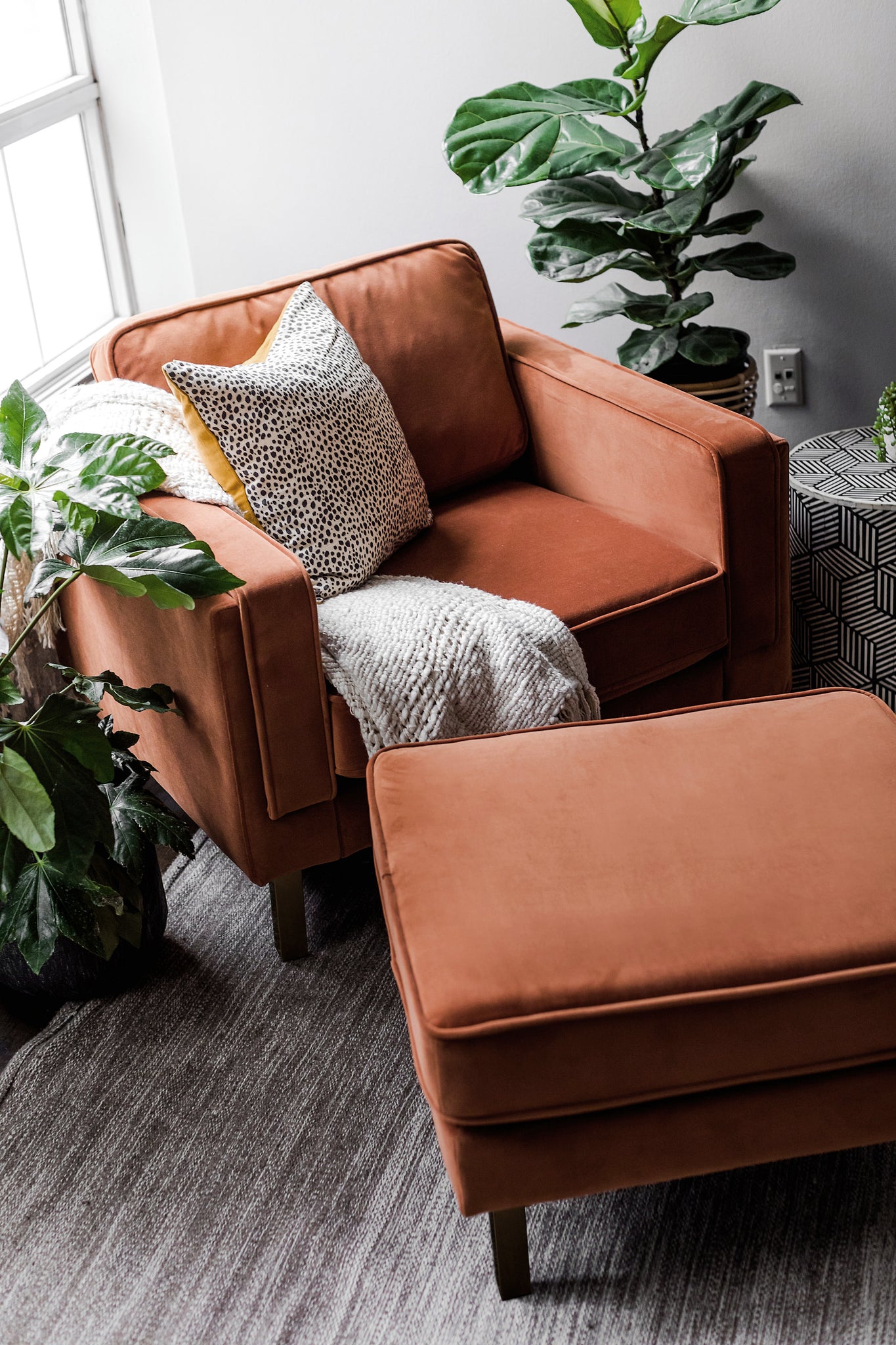 albany ottoman shown in rust velvet with gold legs