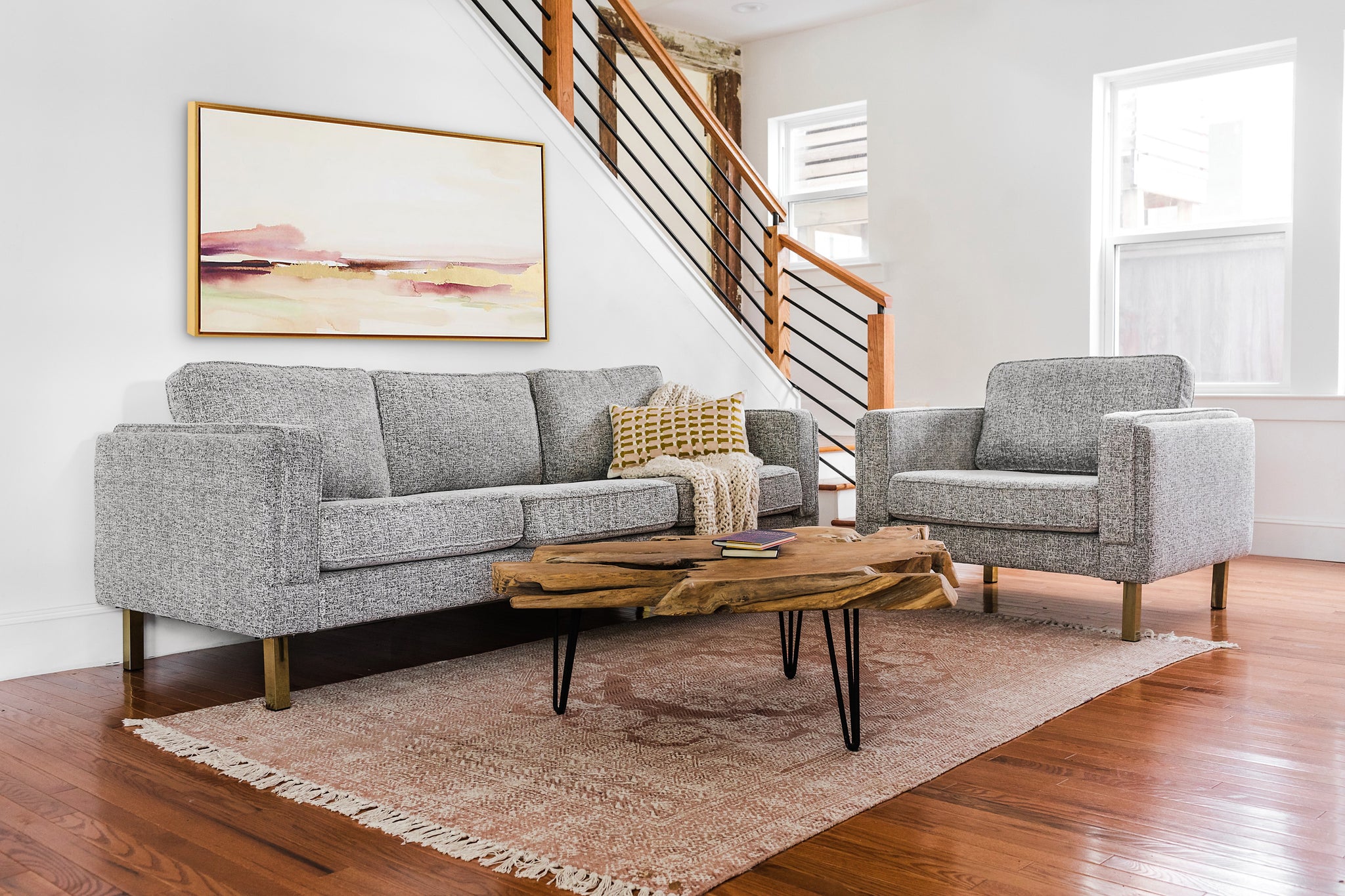 albany armchair shown in grey fabric with gold legs