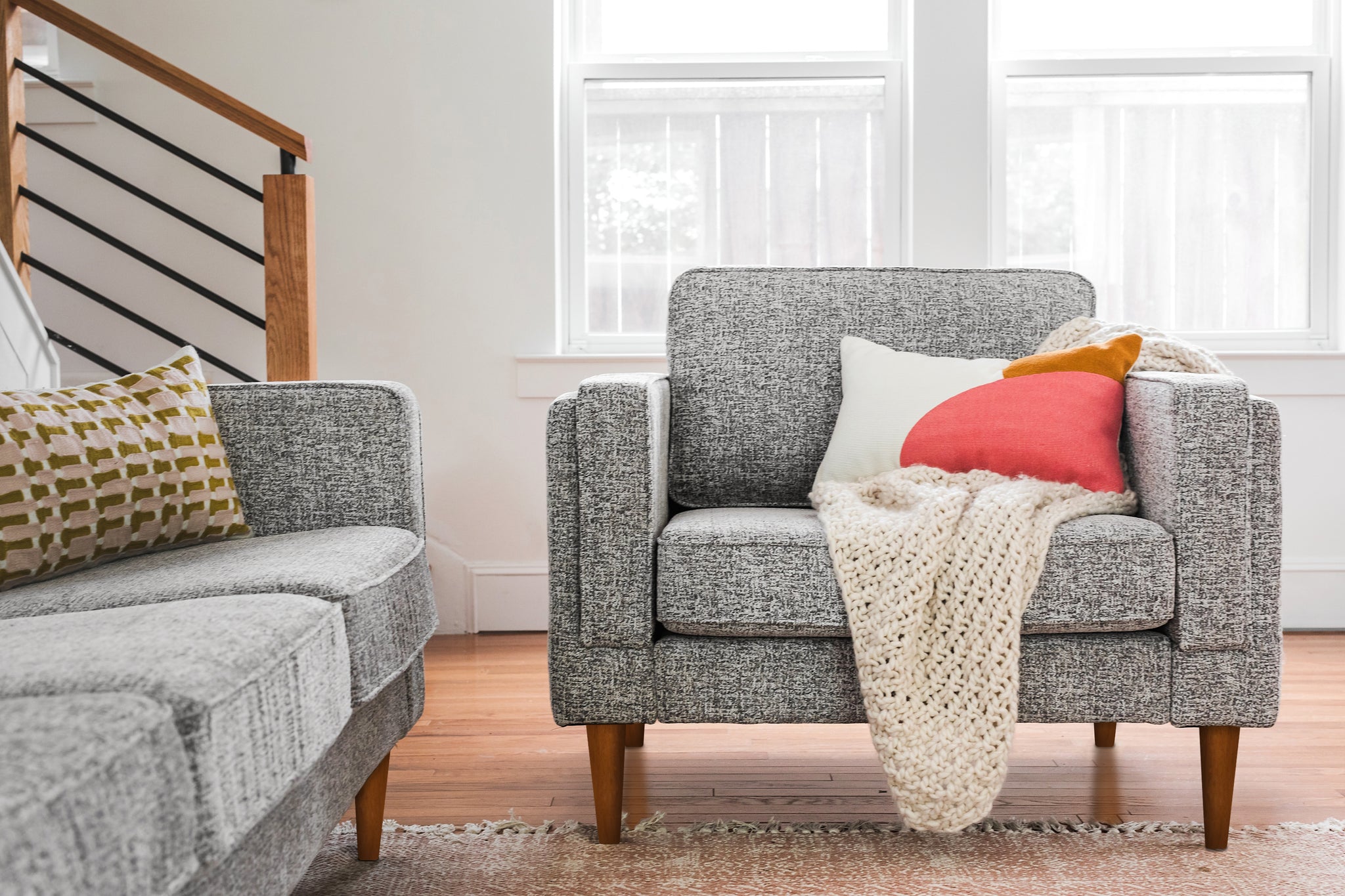 albany armchair shown in grey fabric with walnut legs