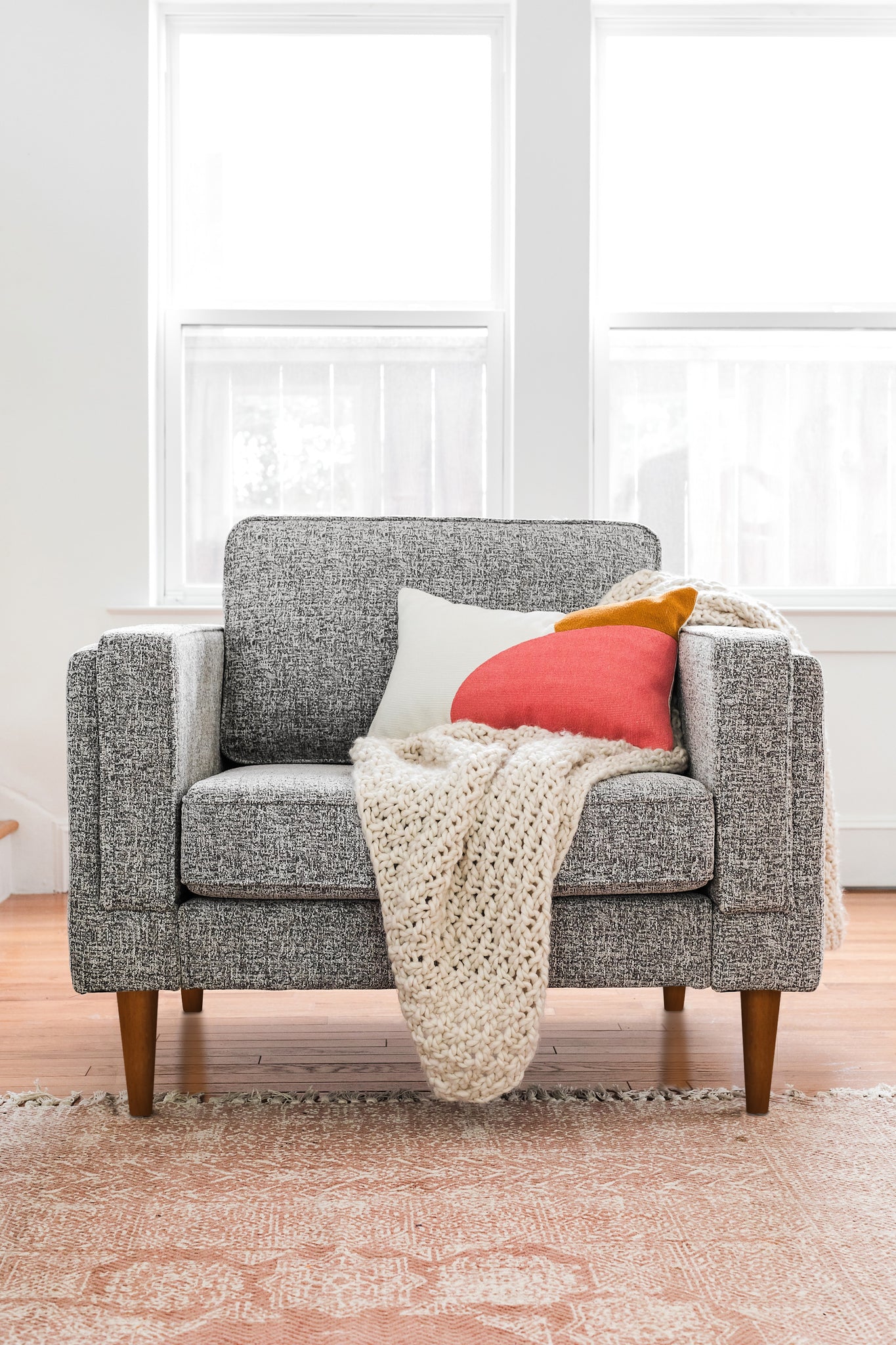 albany armchair shown in grey fabric with walnut legs