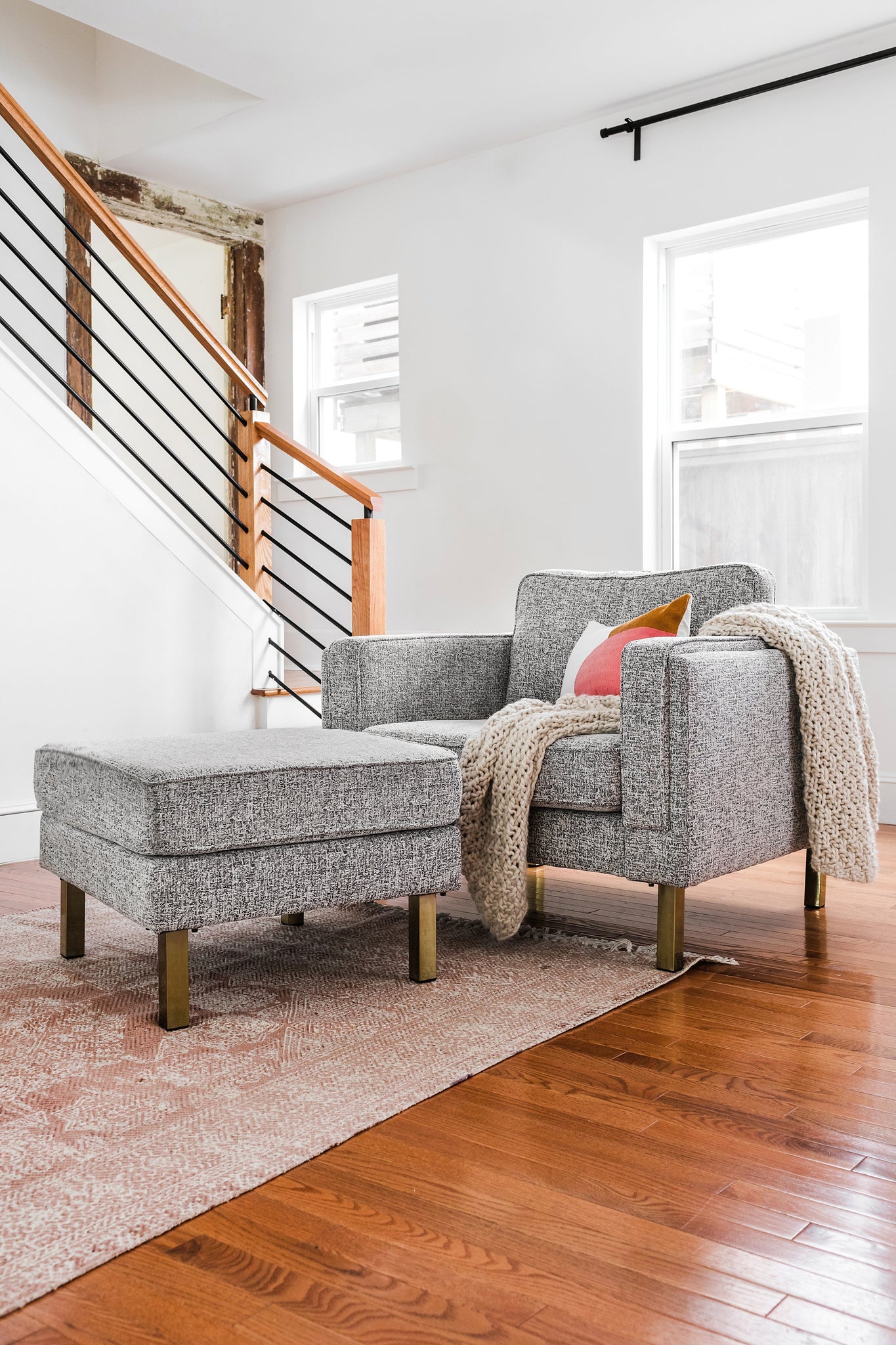 albany armchair shown in grey fabric with gold legs