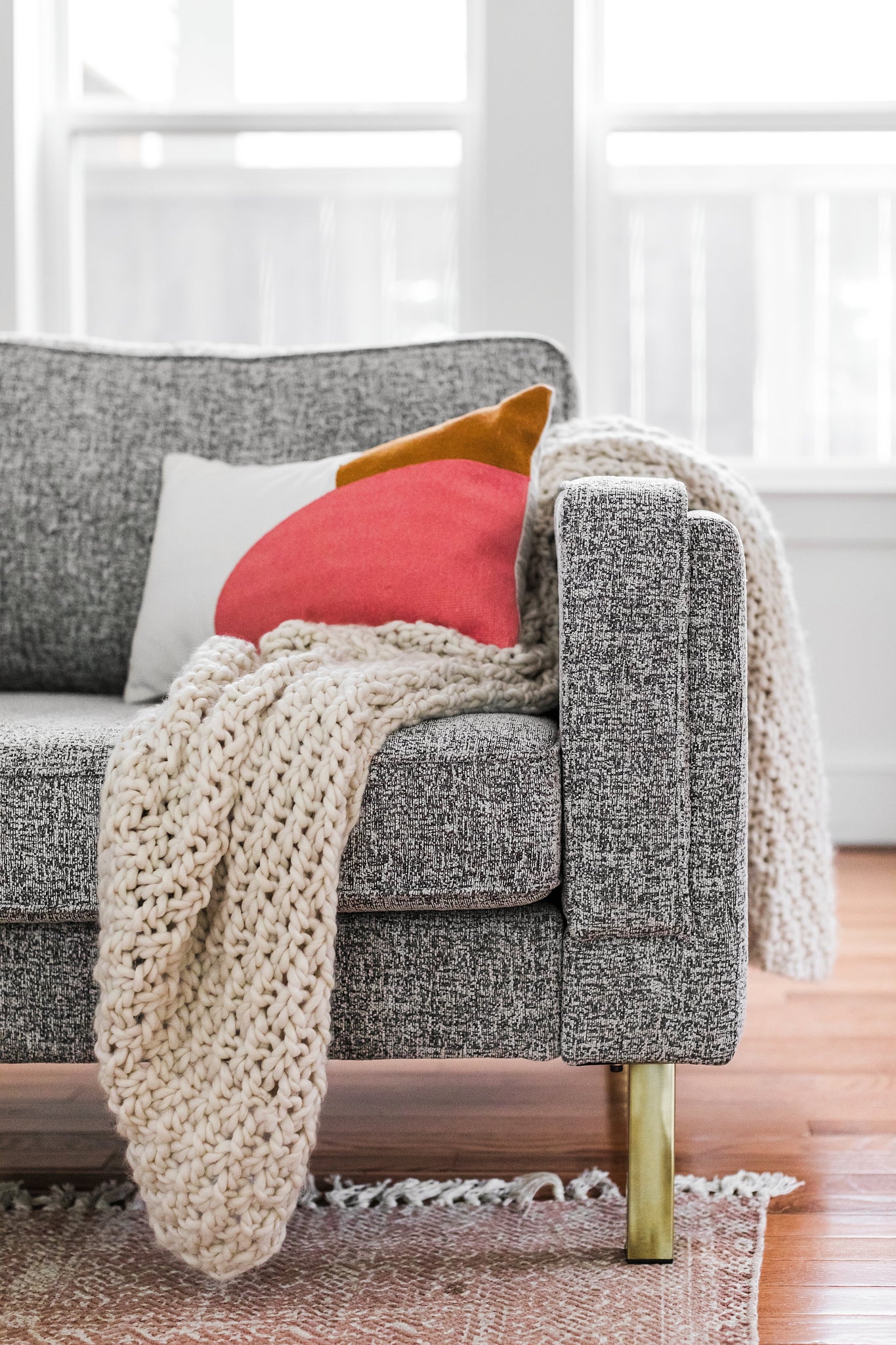 albany armchair shown in grey fabric with gold legs