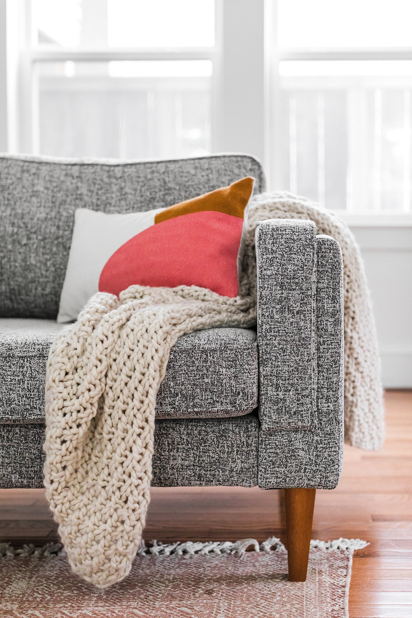 albany armchair shown in grey fabric with walnut legs