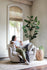 white bouclé | Woman seated in the Park swivel armchair in boucle fabric 