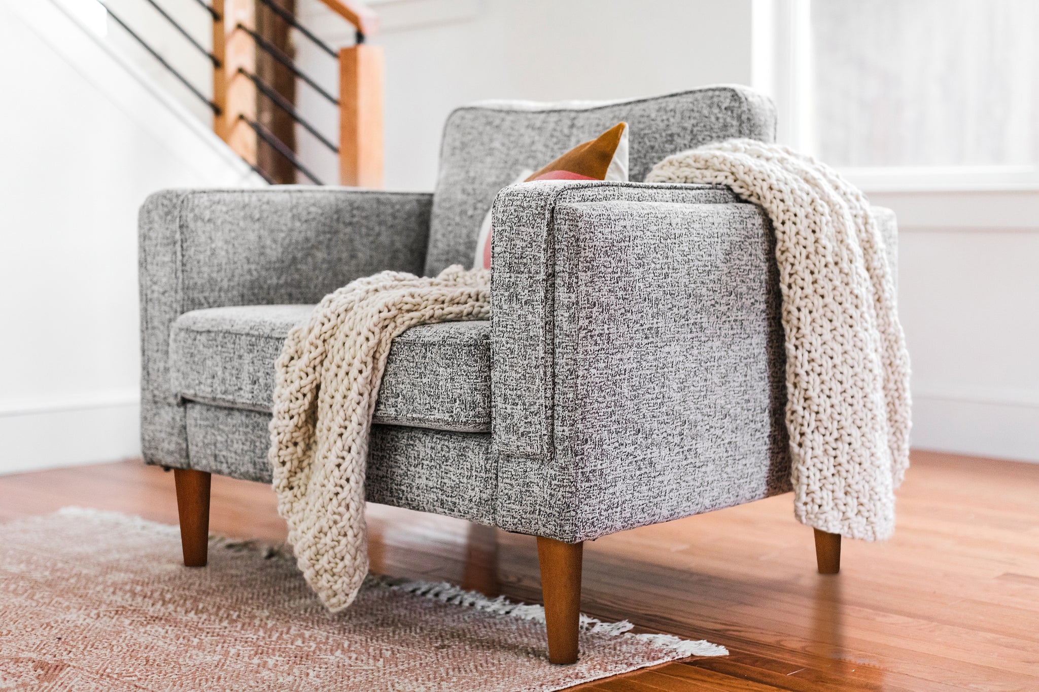 albany armchair shown in grey fabric with walnut legs