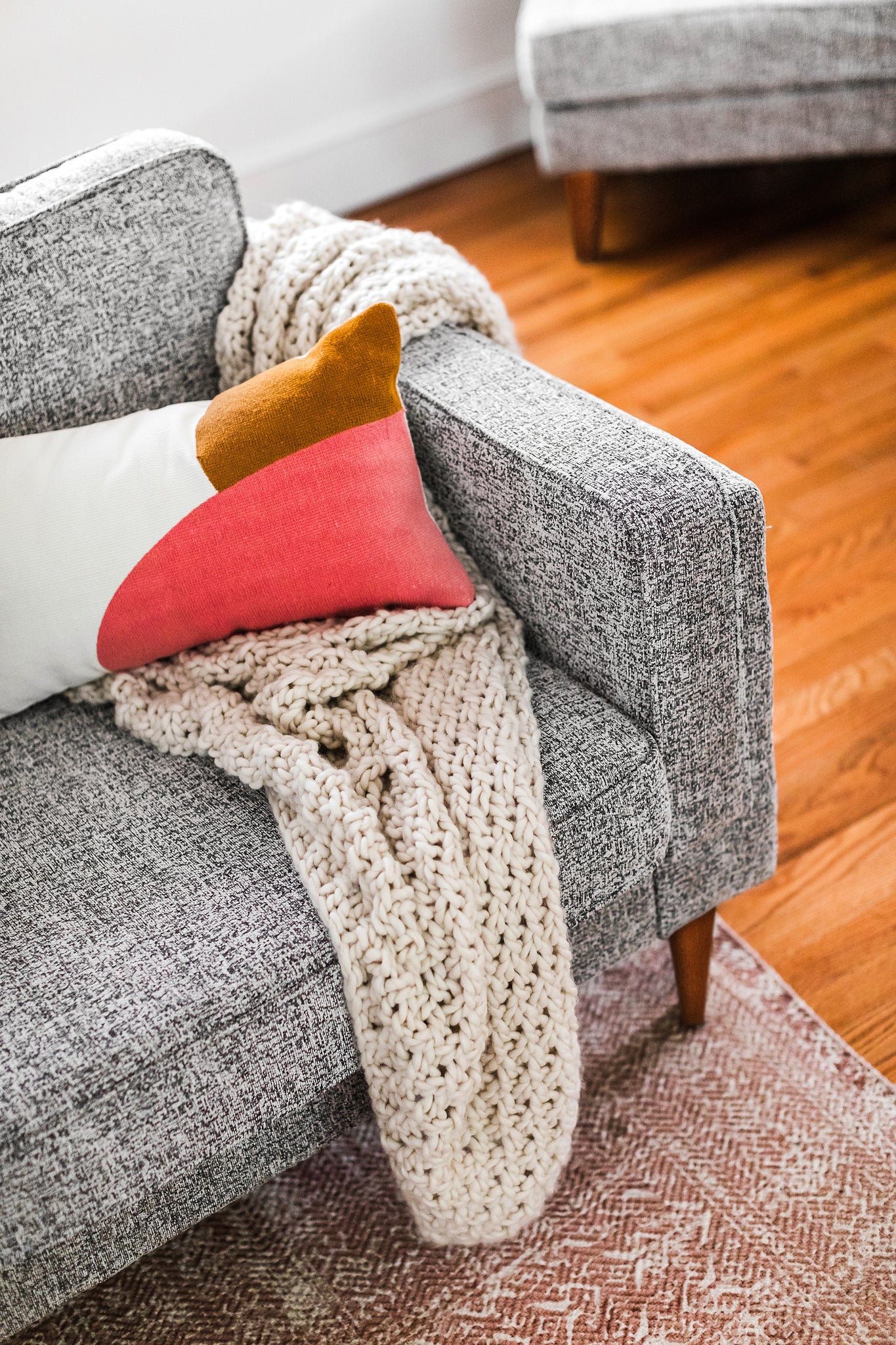 albany armchair shown in grey fabric with walnut legs