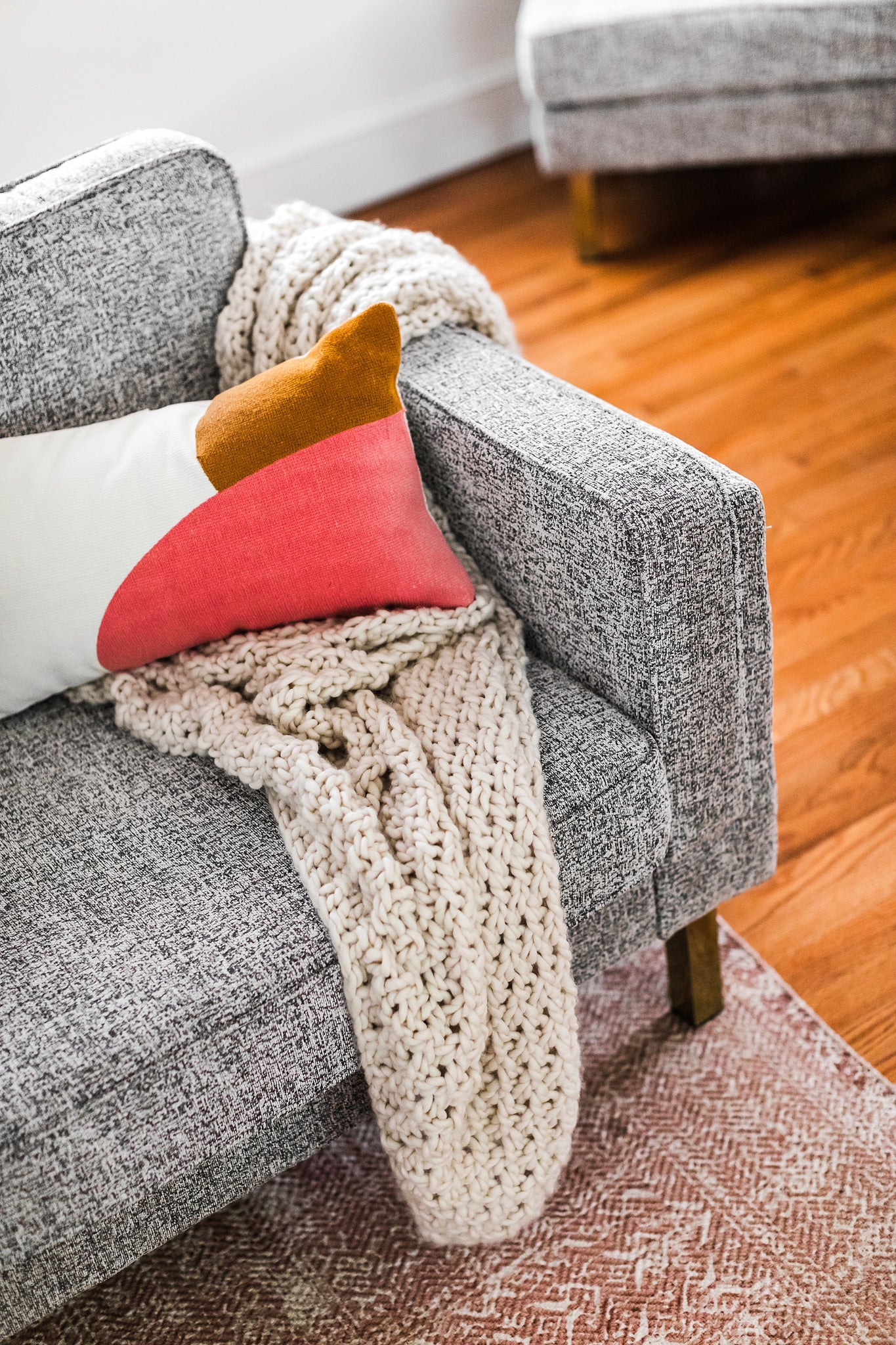albany armchair shown in grey fabric with gold legs