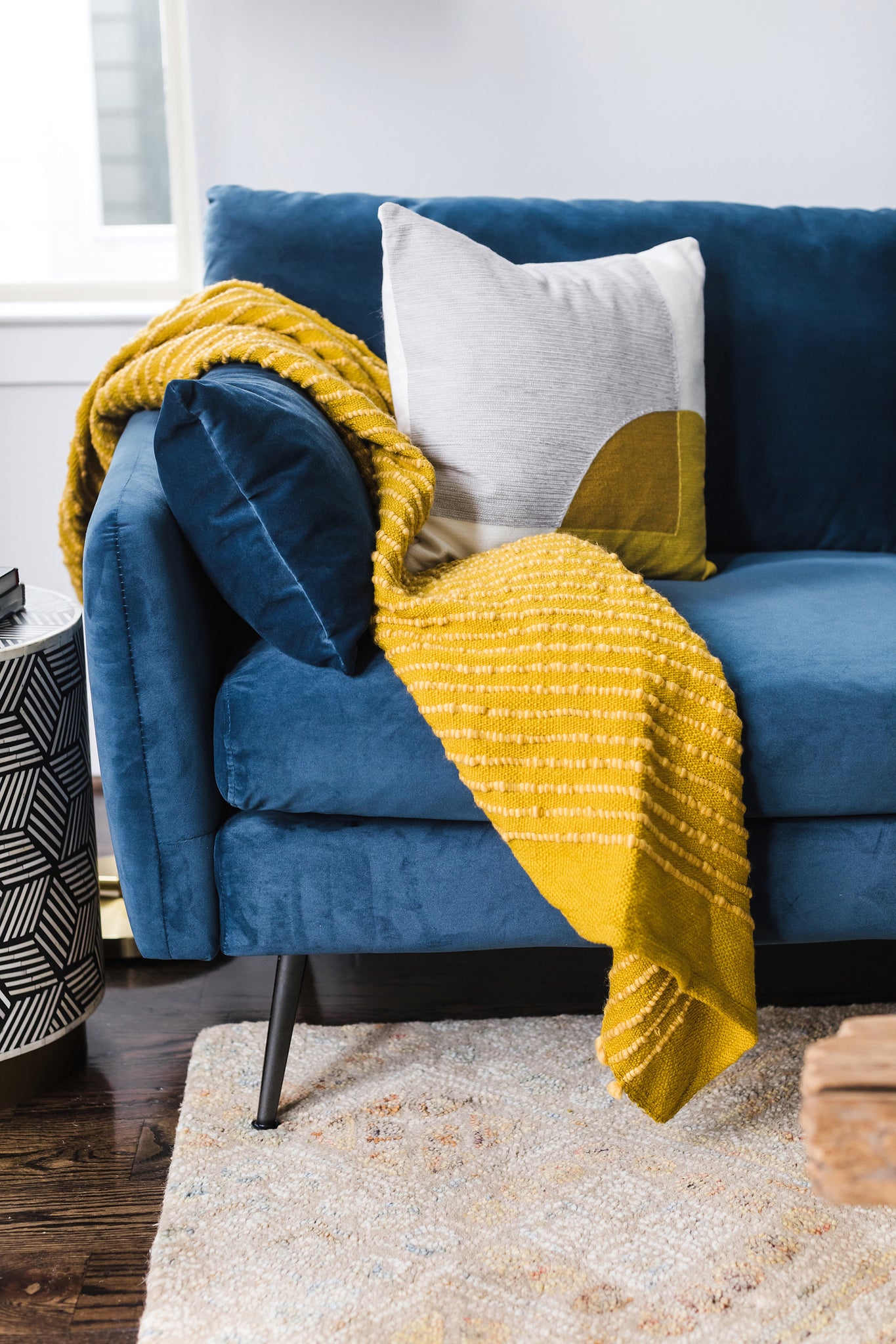 park sectional sofa shown in blue velvet with black legs right facing
