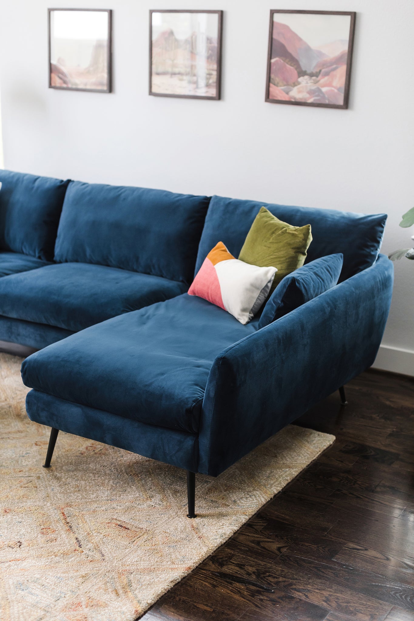 park sectional sofa shown in blue velvet with black legs right facing