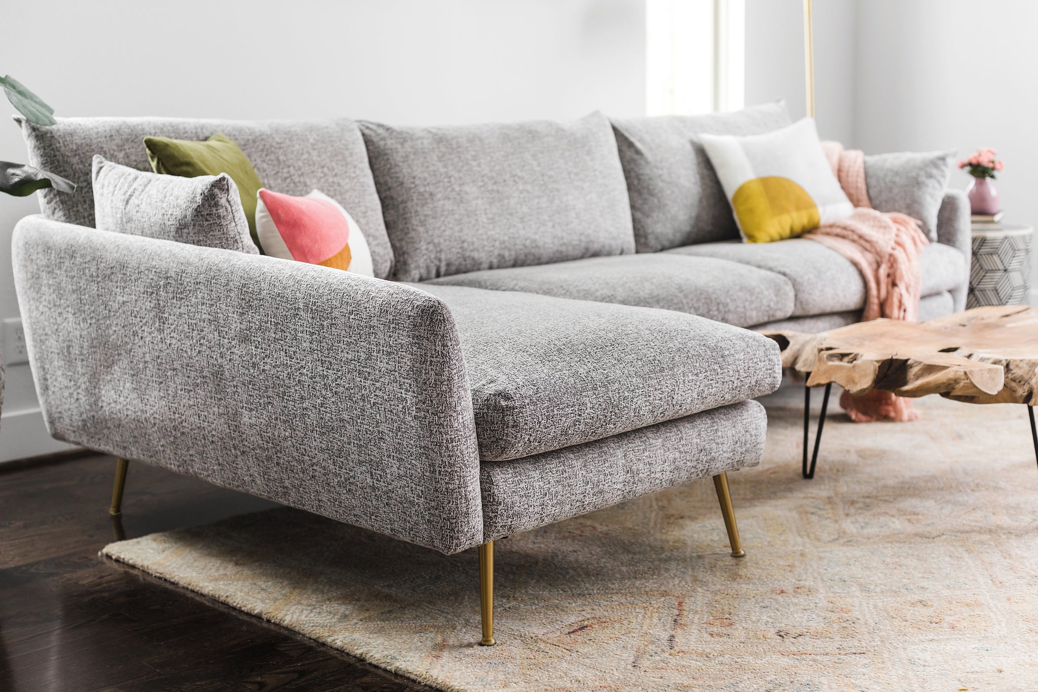 park sectional sofa shown in grey fabric with gold legs left facing