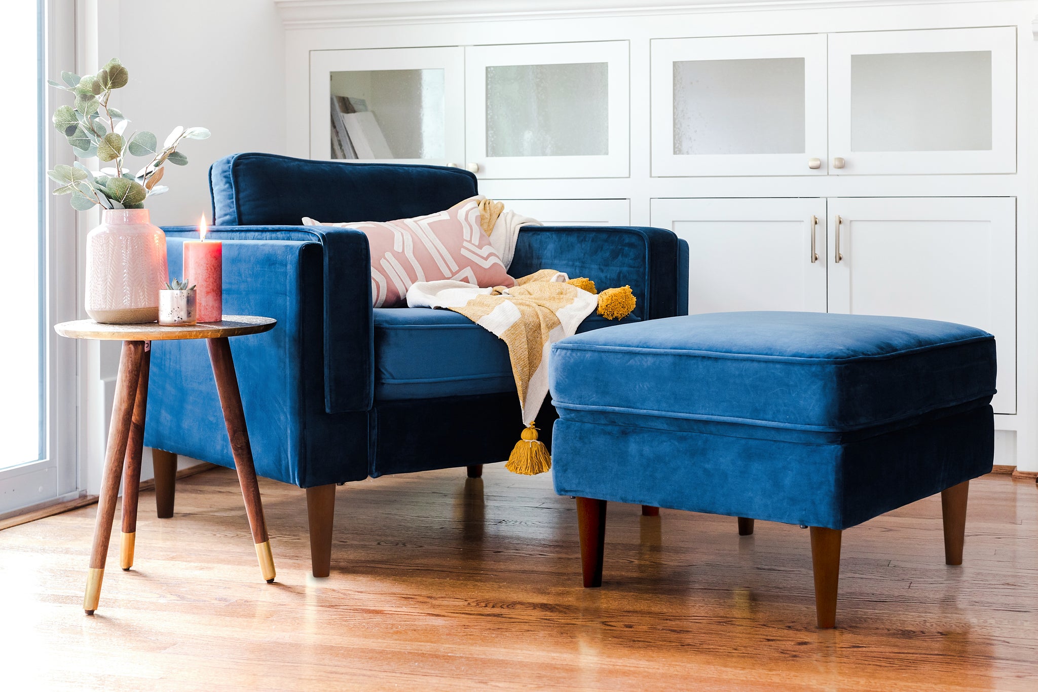 albany ottoman shown in blue velvet with walnut legs
