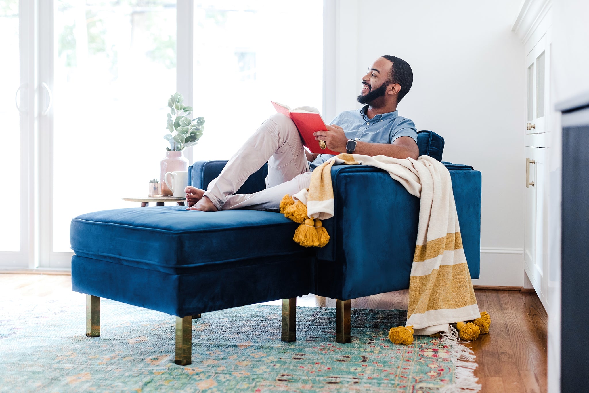 albany ottoman shown in blue velvet with gold legs