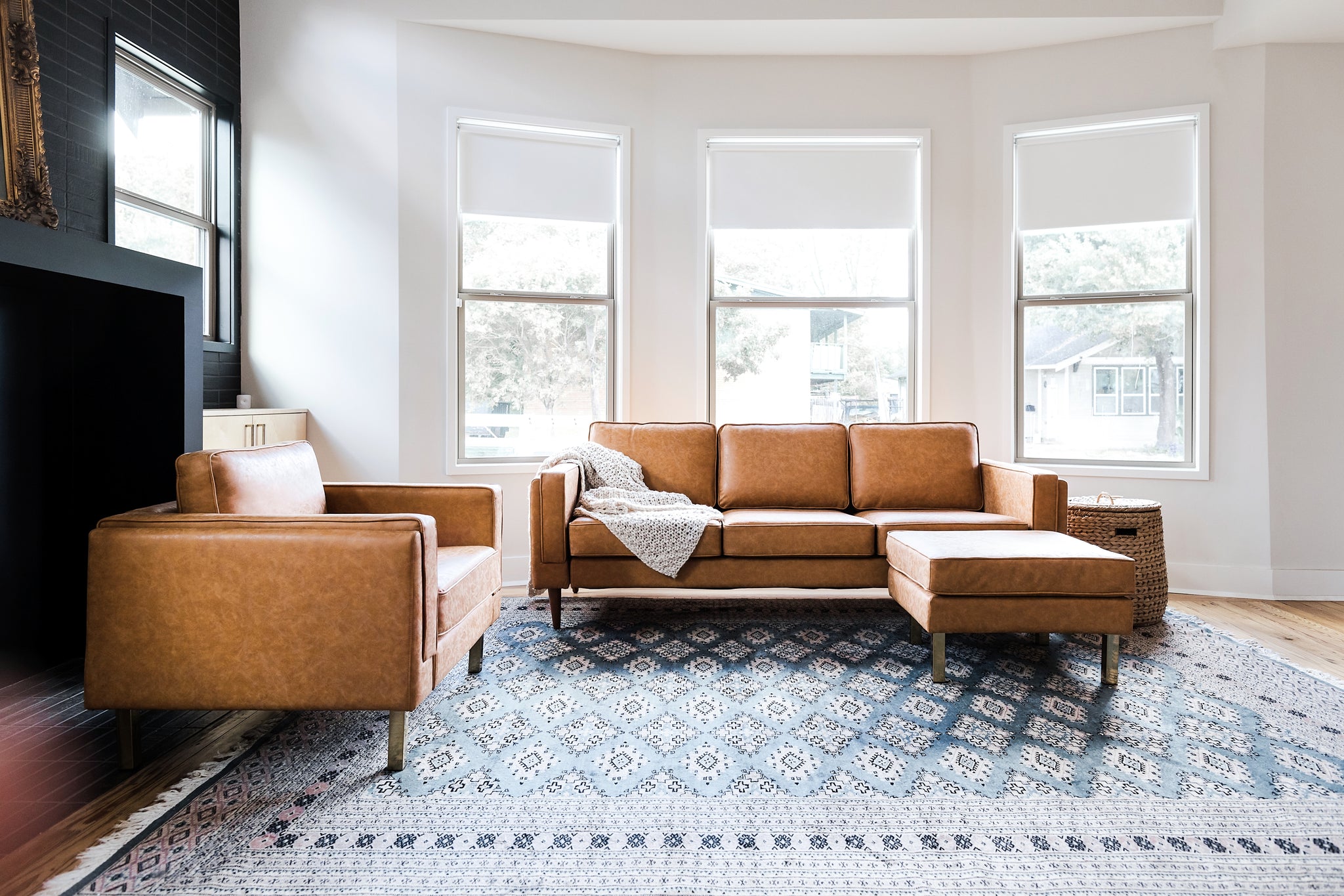 albany ottoman shown in distressed vegan leather with gold legs