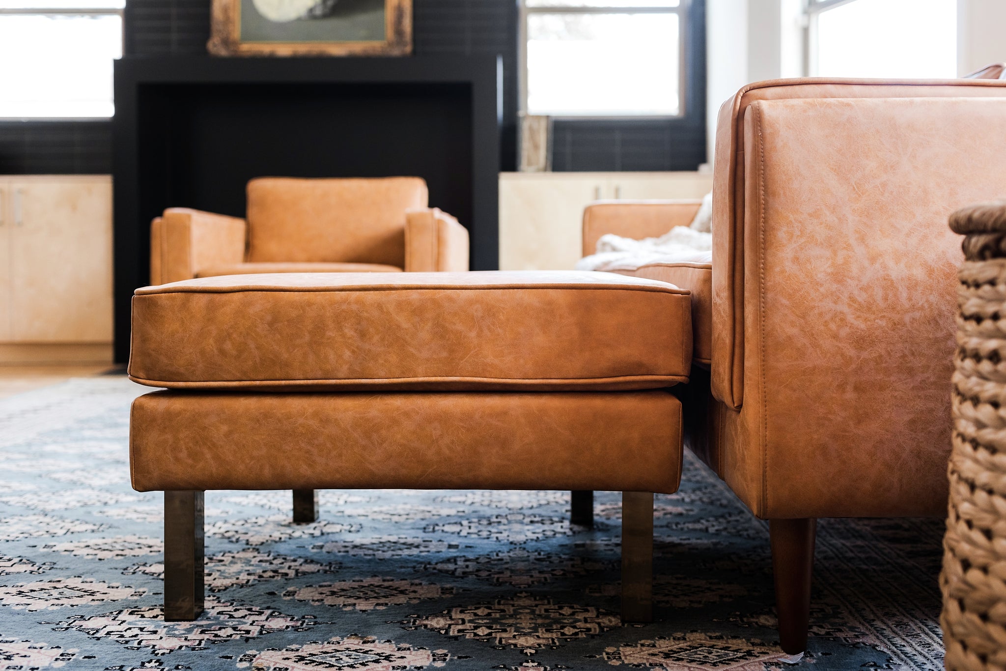 albany ottoman shown in distressed vegan leather with gold legs