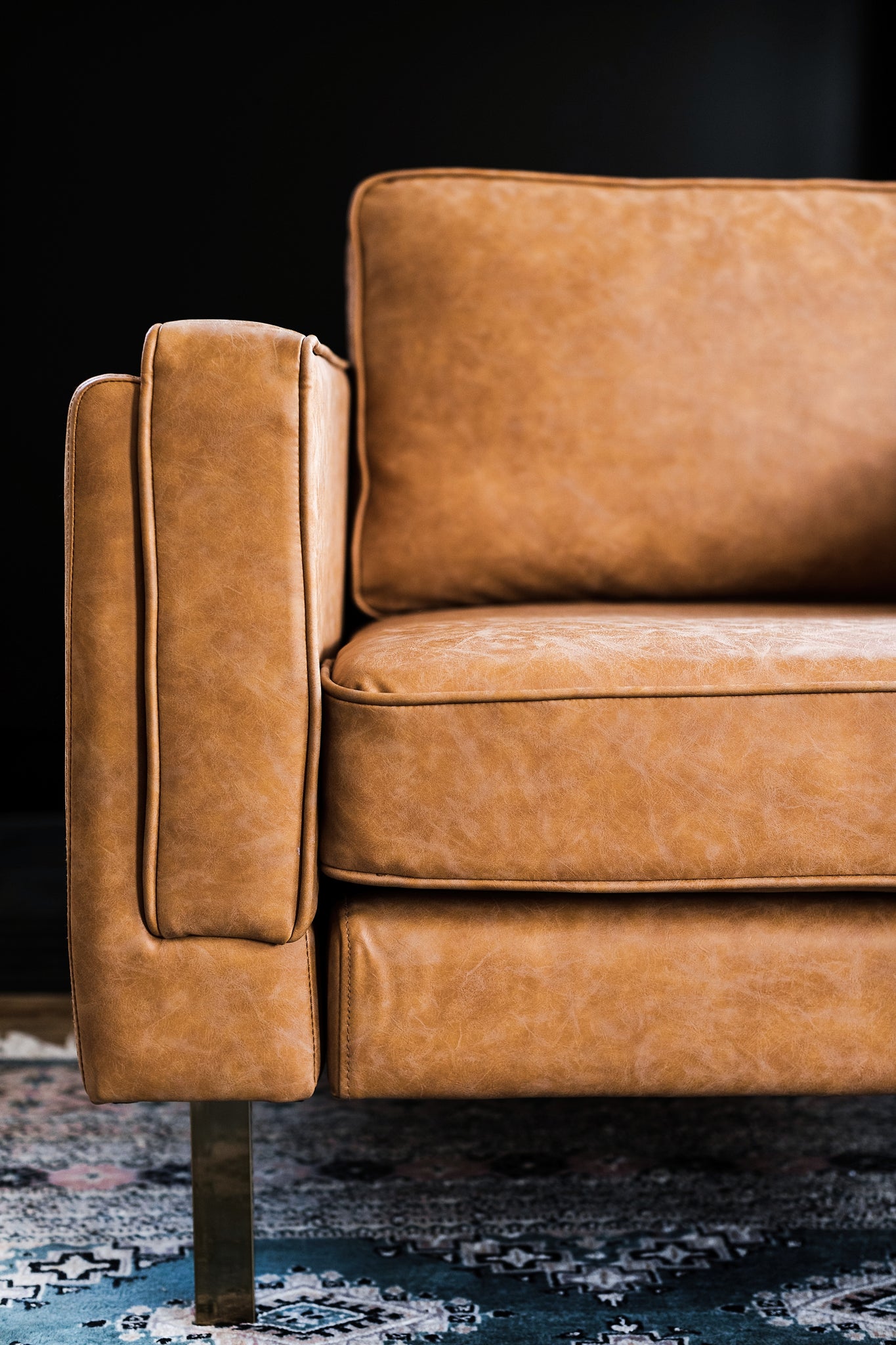 albany armchair shown in distressed vegan leather with gold legs