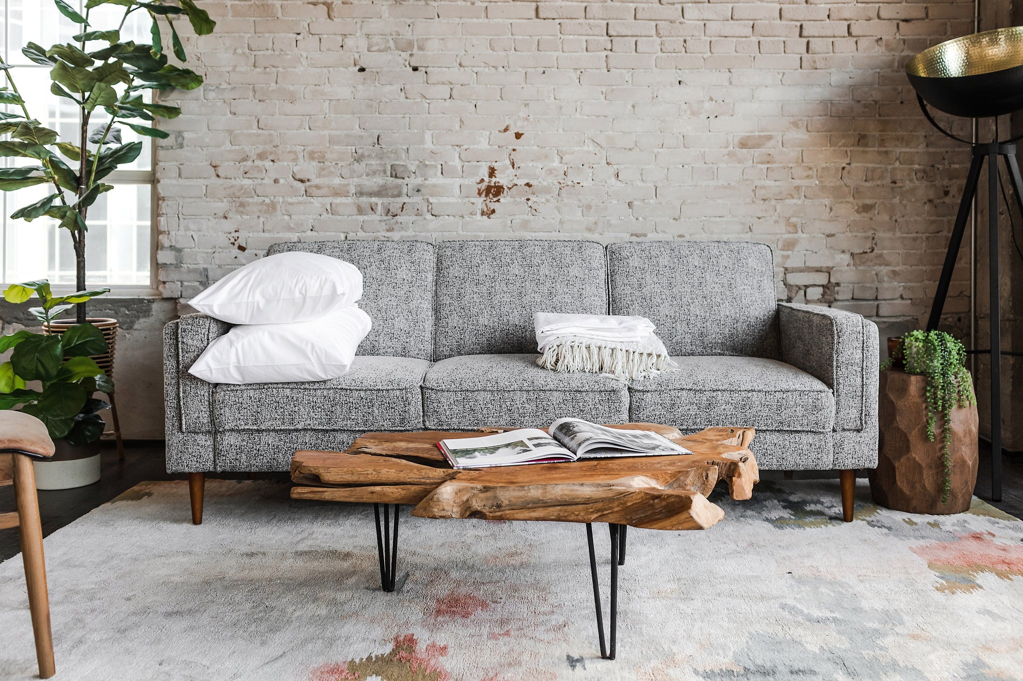 albany sleeper sofa in grey fabric with walnut legs in a living room setting