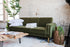 olive velvet gold | Albany sleeper sofa in olive velvet with gold legs with two pillows and a blanket on top