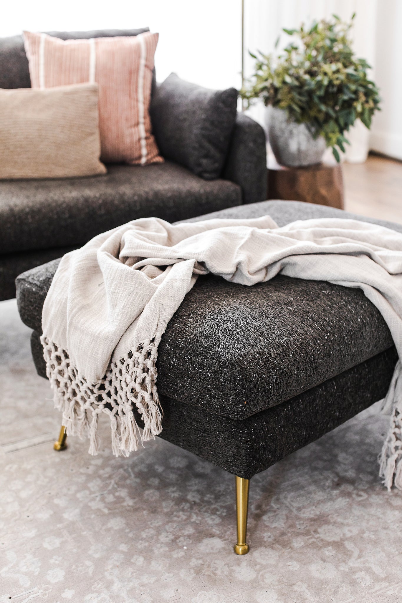park ottoman shown in charcoal with gold legs