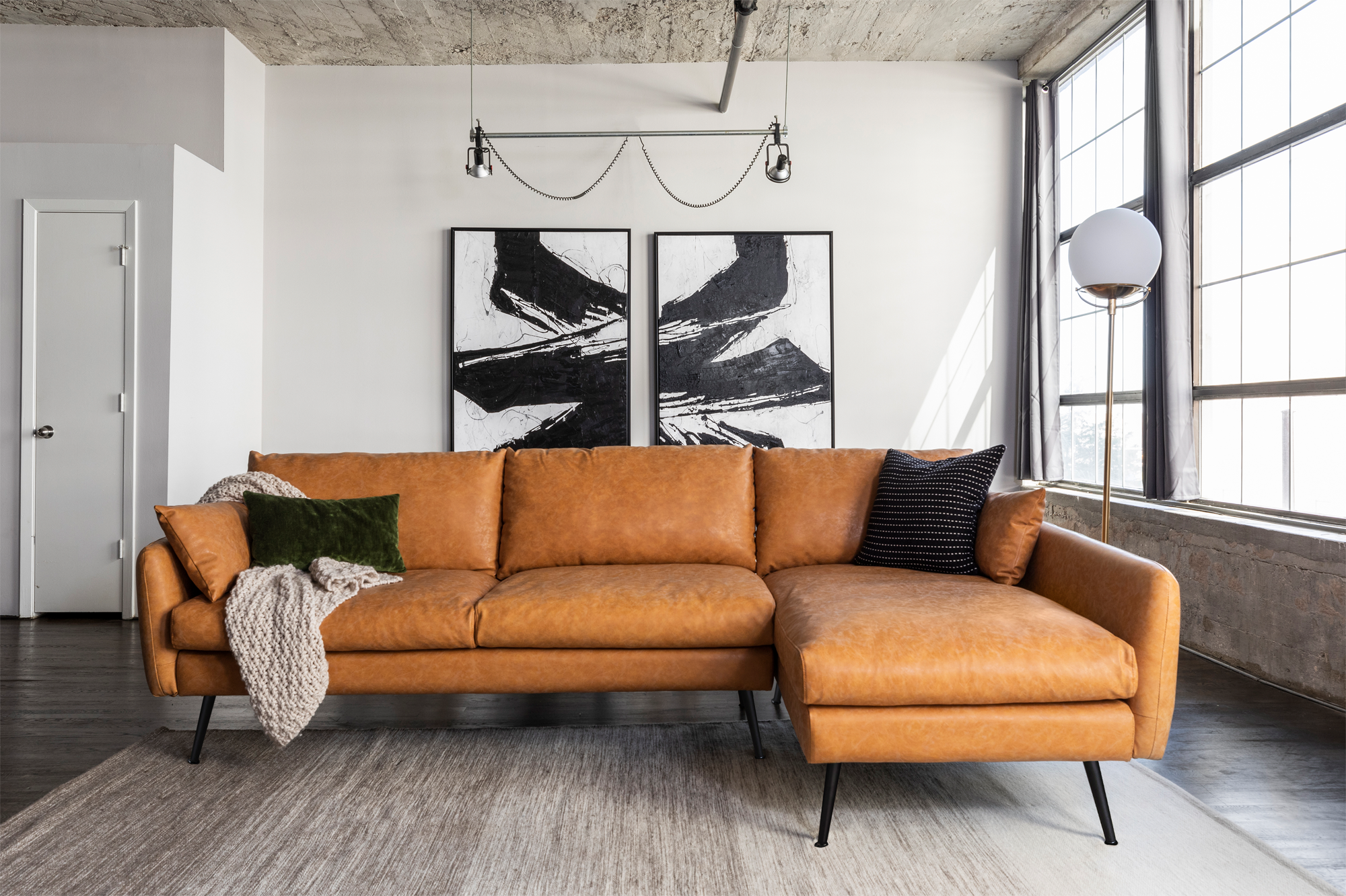 park sectional sofa shown in distressed vegan leather with black legs right facing