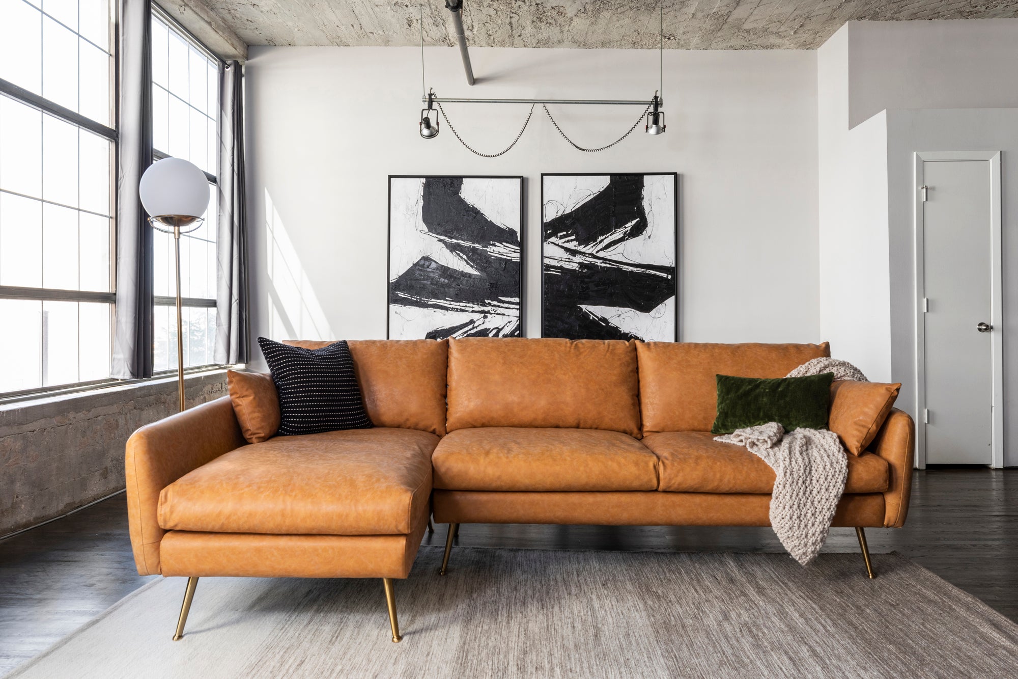 park sectional sofa shown in distressed vegan leather with gold legs left facing