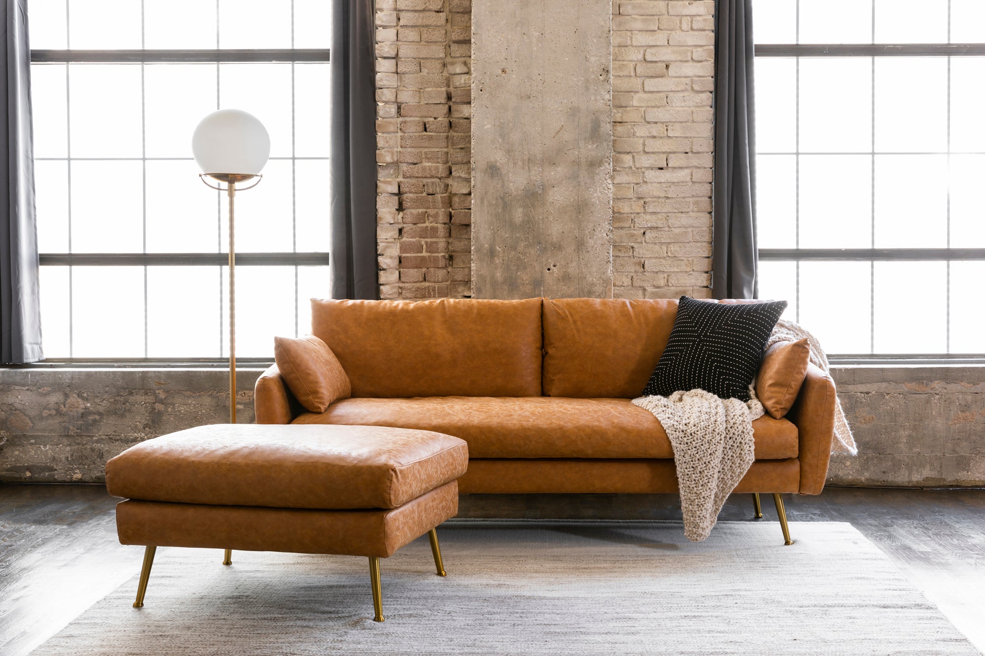 park sofa shown in distressed vegan leather with gold legs