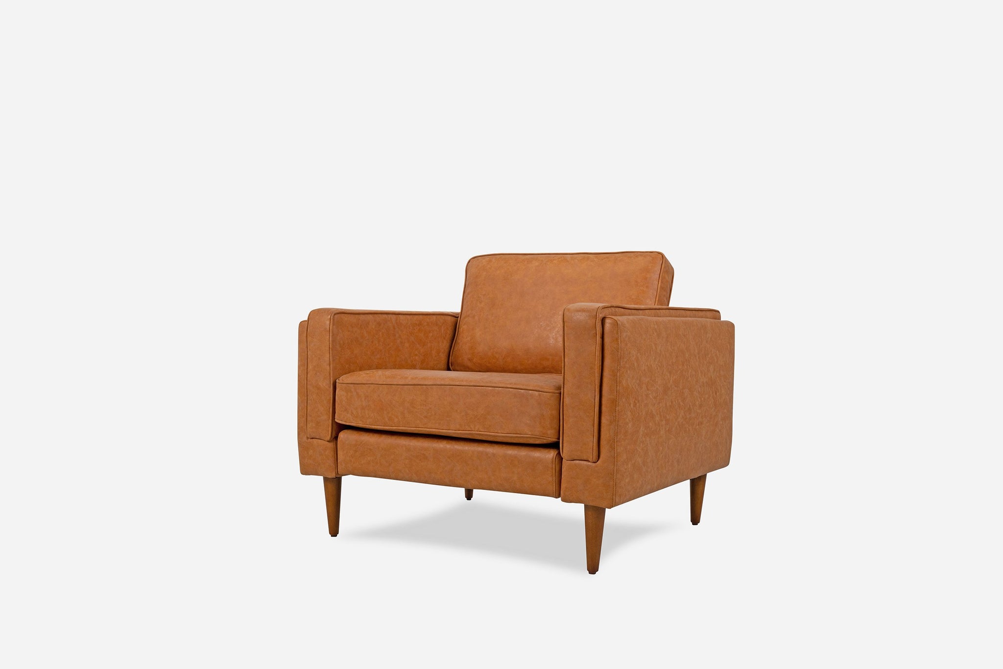 albany armchair shown in distressed vegan leather with walnut legs