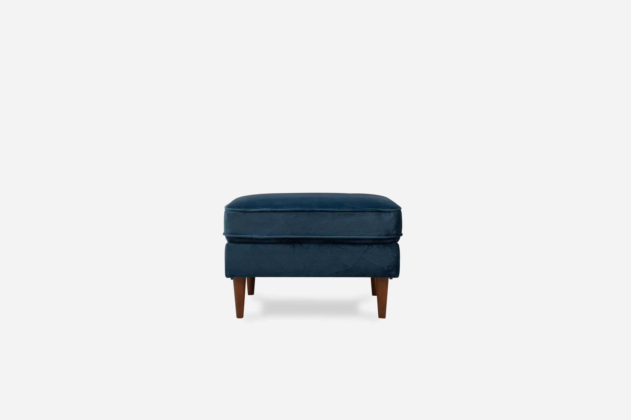 albany ottoman shown in blue velvet with walnut legs