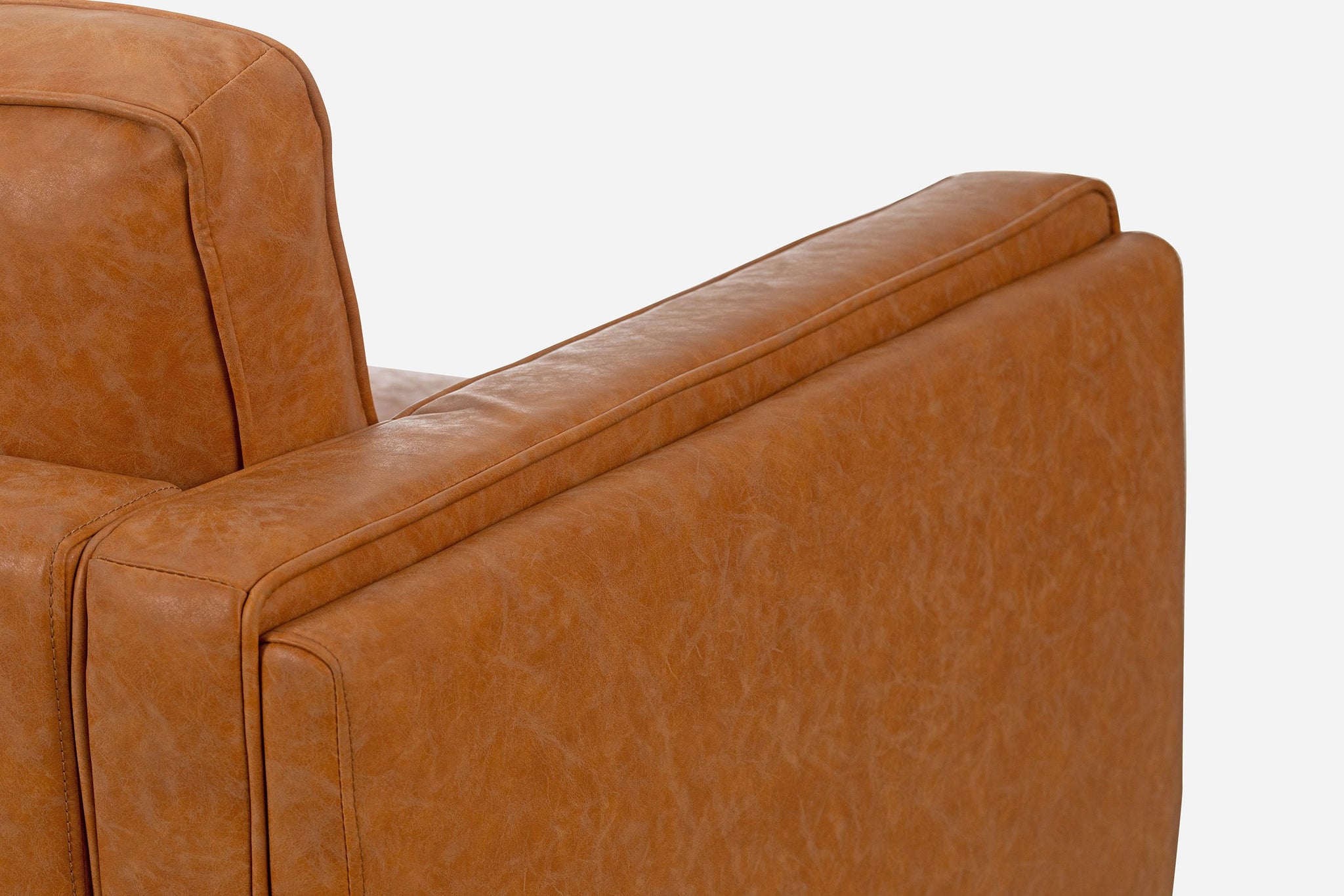albany armchair shown in distressed vegan leather with walnut legs