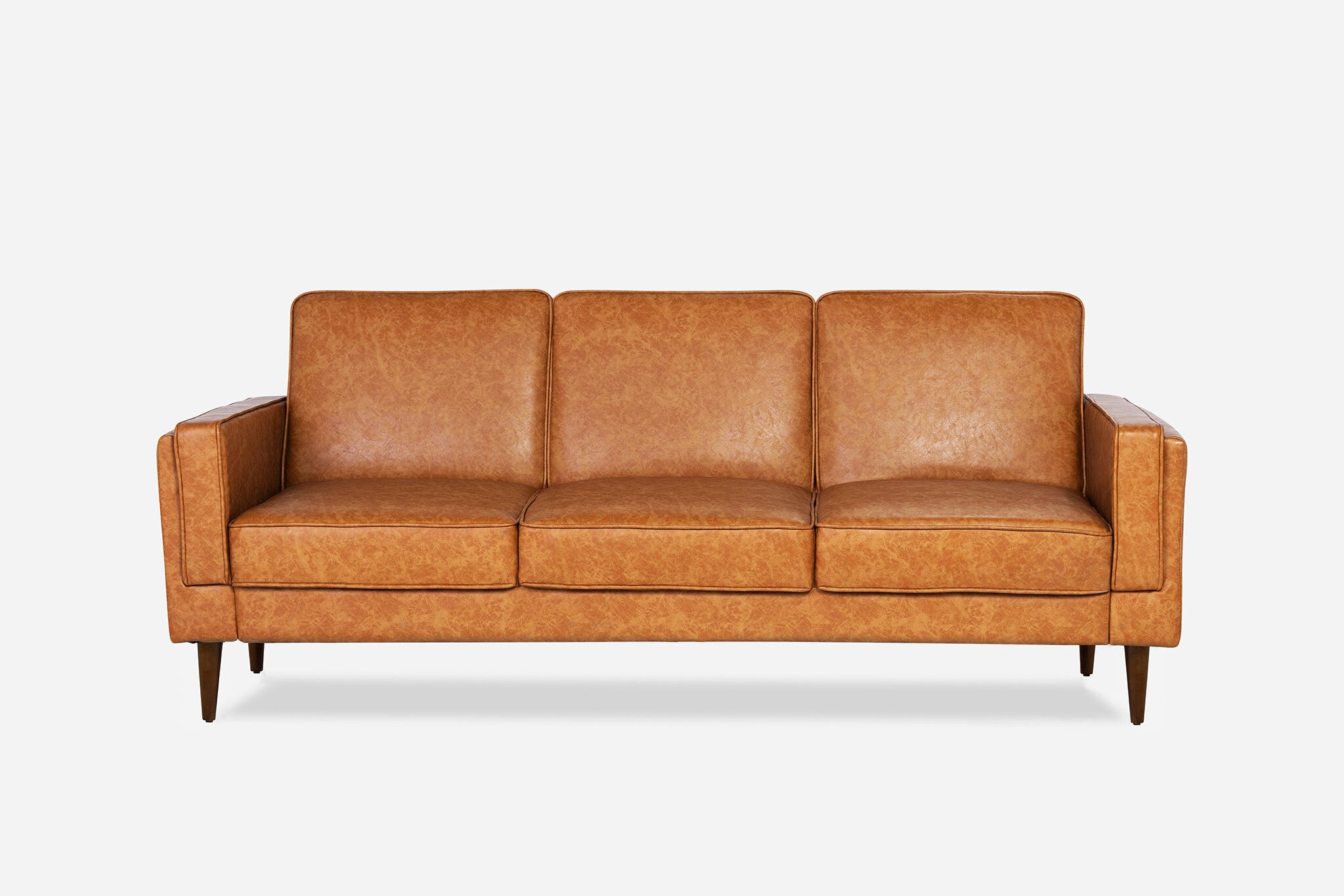 front view of the albany sleeper sofa in vegan leather with walnut legs